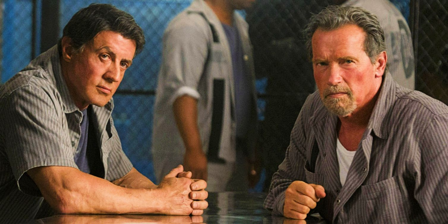 Sylvester Stallone and Arnold Schwarzenegger sitting at a table in Escape Plan-1