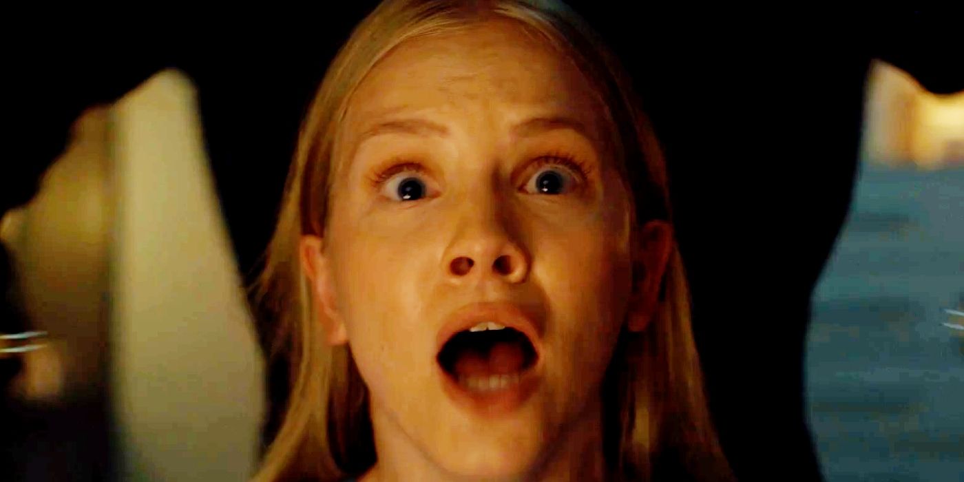 A woman screaming with a dark figure behind her in Thanksgiving.