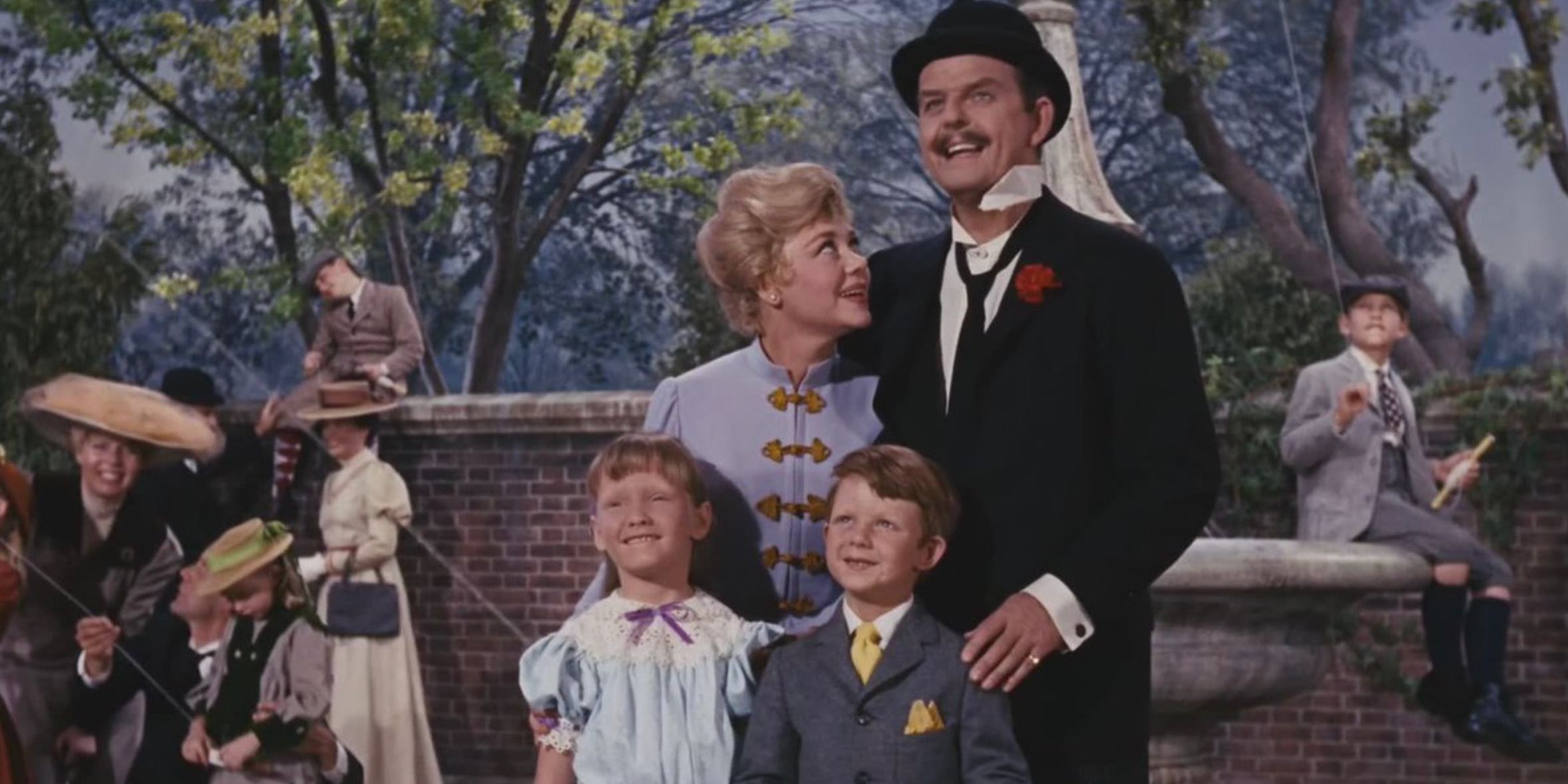 The Banks family at the park flying a kite in Mary Poppins