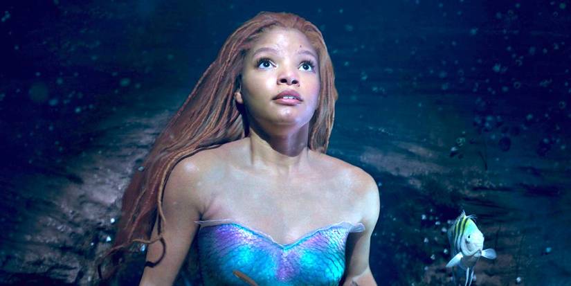Halle Bailey as Ariel looking surprised towards the surface in The Little Mermaid