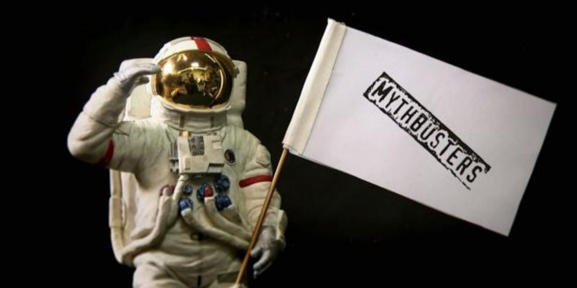 An astronaut holding a flag that says Mythbusters