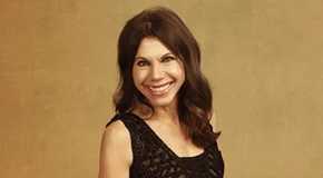 Theresa Nist The Golden Bachelor smiling for the camera in black, lacy dress