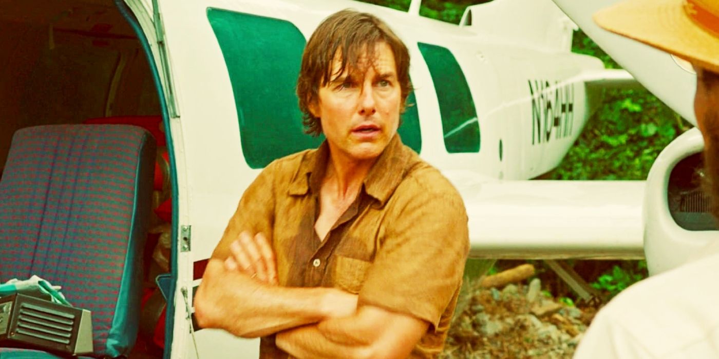 Tom Cruise with his arms crossed as Barry Seal in American Made.