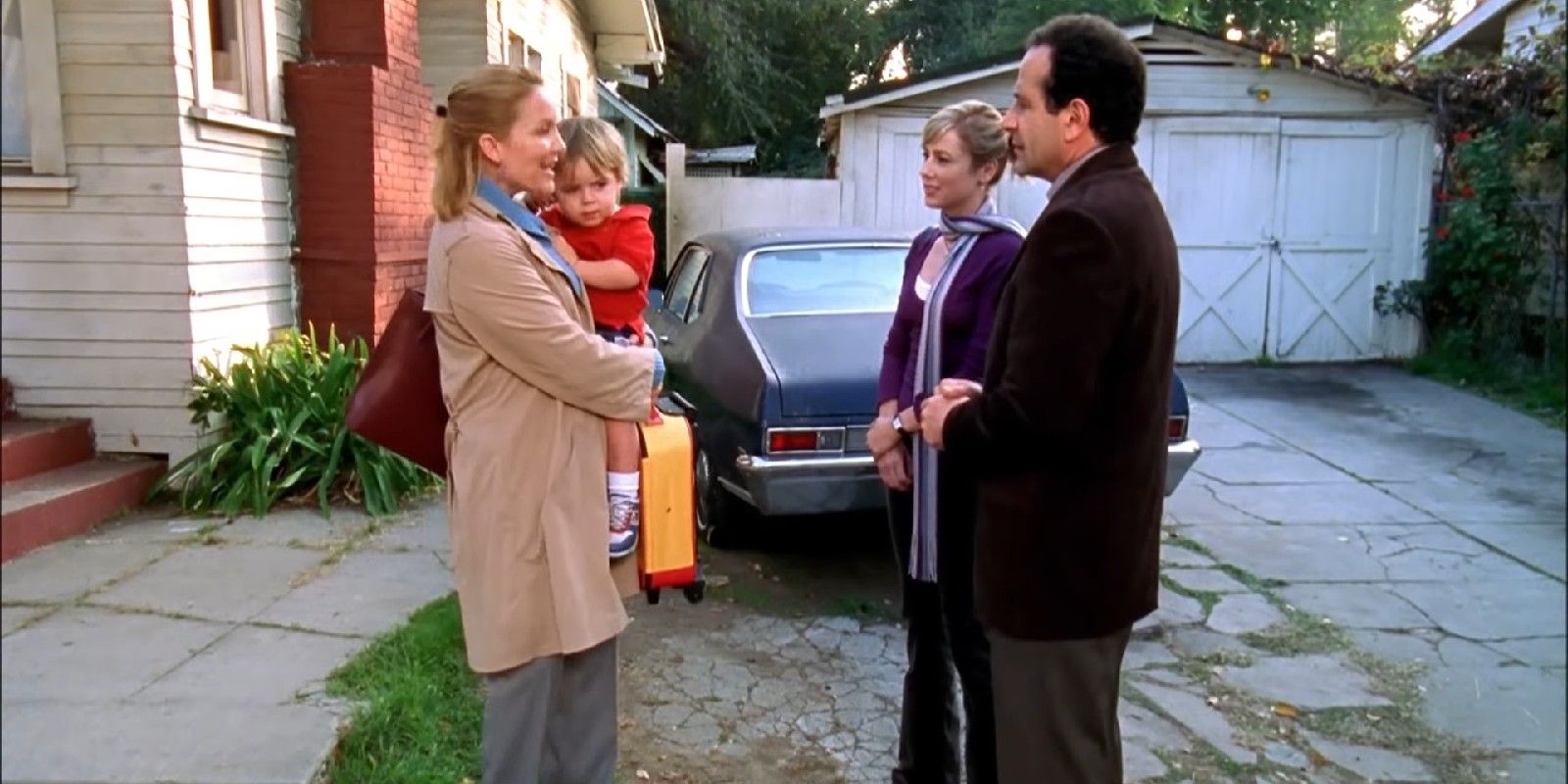 A woman carries a child while speaking with Natalie and Monk in Monk