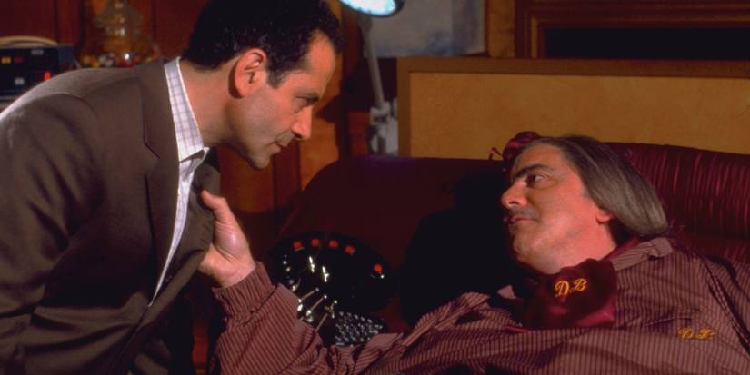 Tony Shalhoub as Monk with another man grabbing the lapel of his suit in Mr MOnk meets Dale the Whale