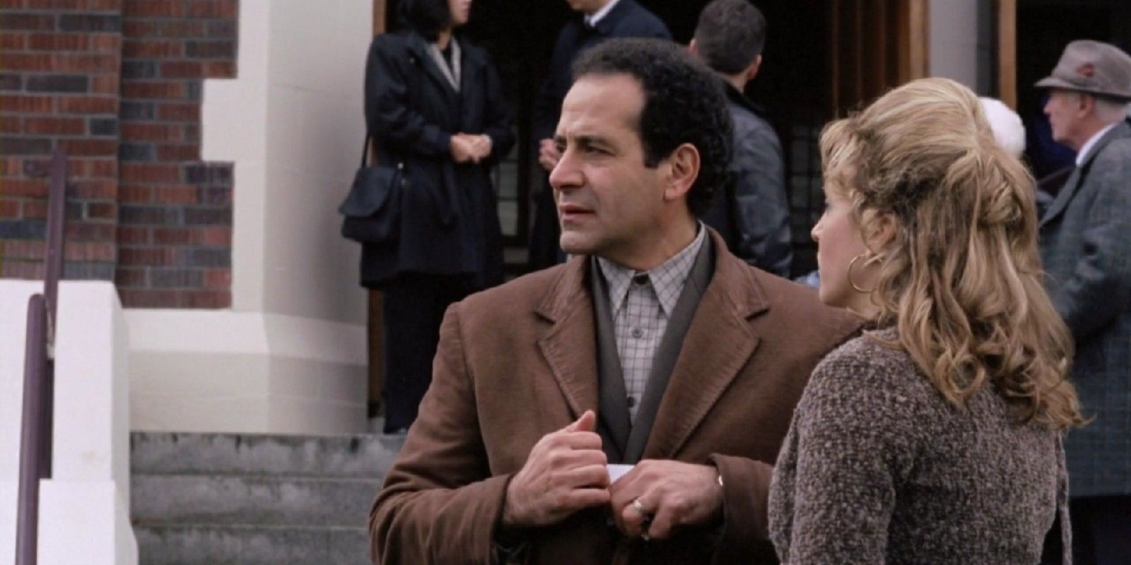 Monk and Sharona standing outside of a brick building in the premiere of Monk