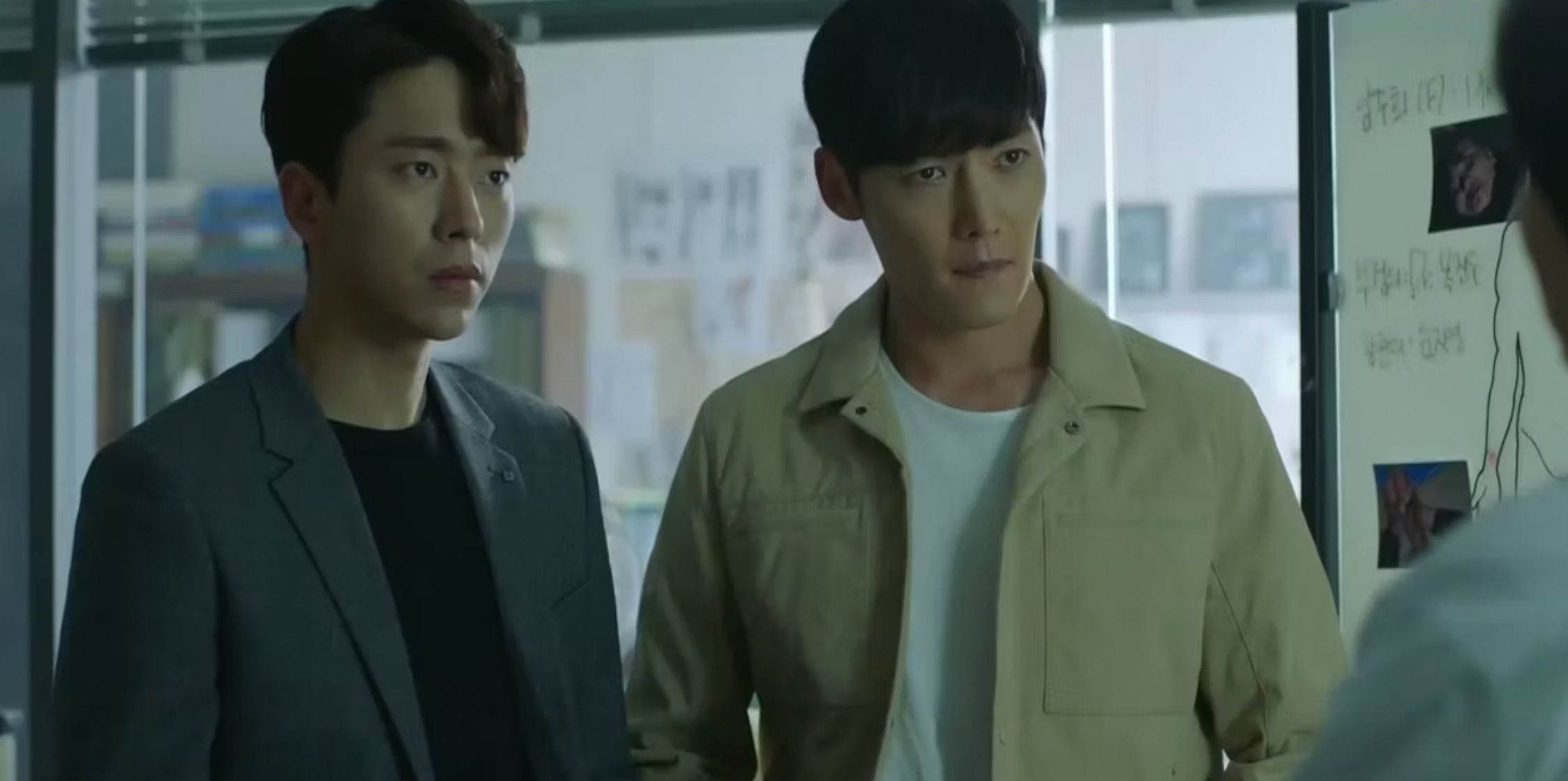 Two men listen attentively to someone else in the time travel Kdrama Tunnel
