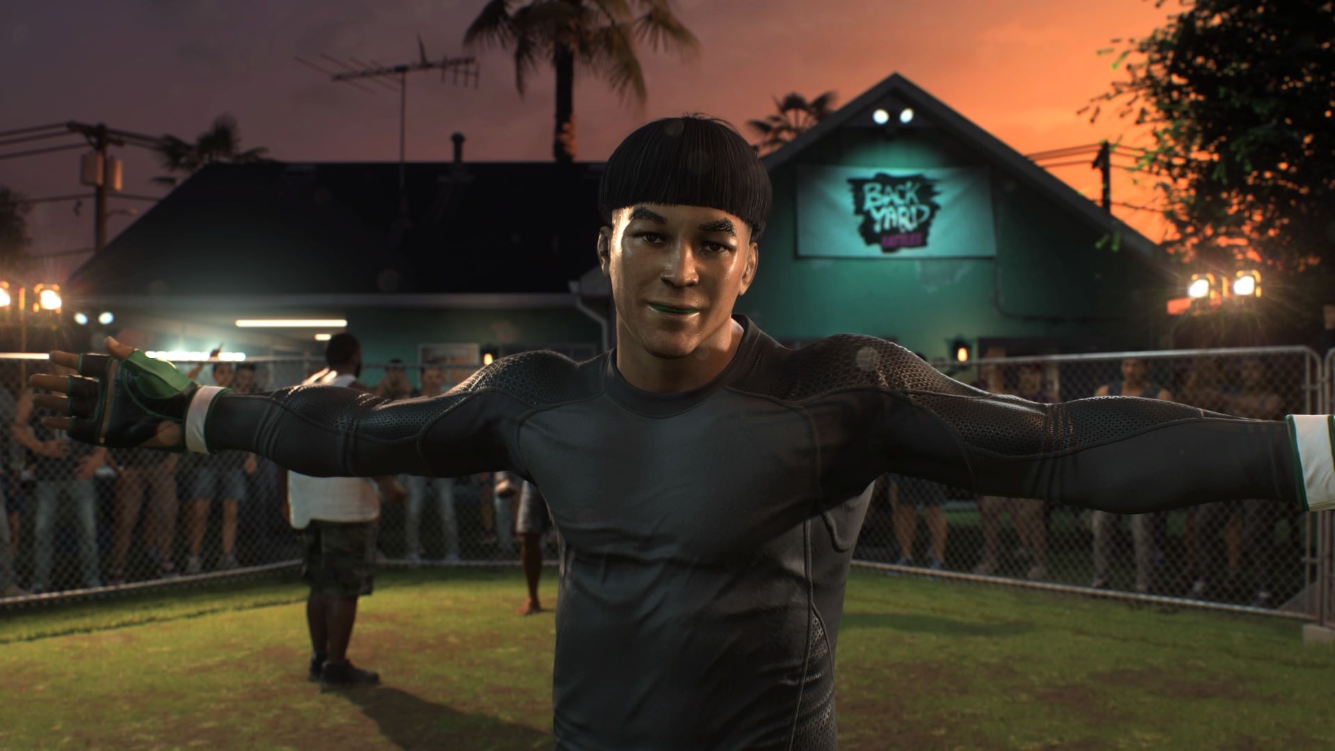 Screenshot from UFC 5 shows custom fighter celebrating after a win in a backyard match. A chainlink fence blocks off the arena with onlookers behind it. Character has black hair and a bowl cut.