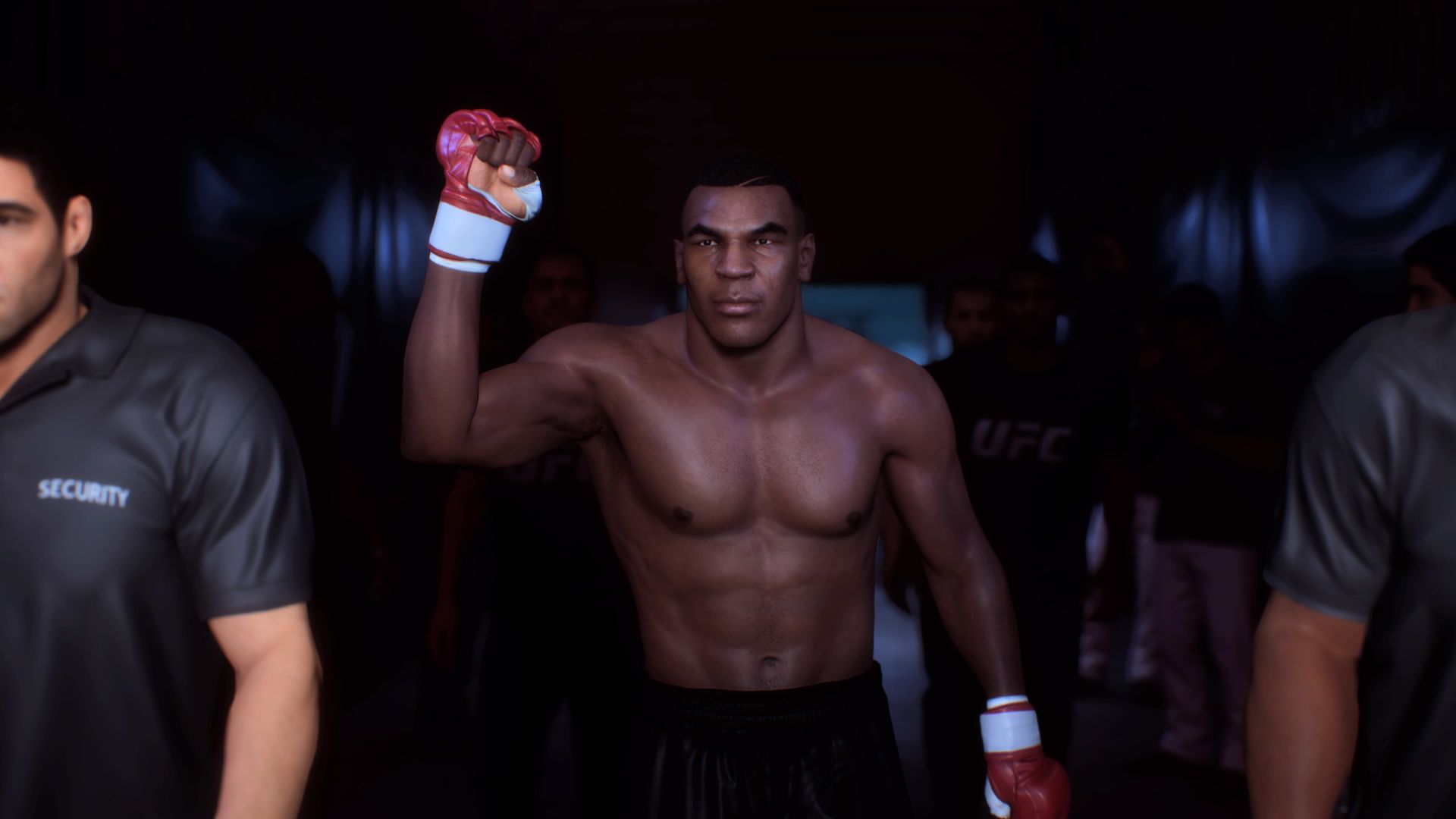 Screenshot from UFC 5 shows boxer Mike Tyson walkout out towards the octagon with one fist clenched held into the air while he's escorted to the ring by secruity.