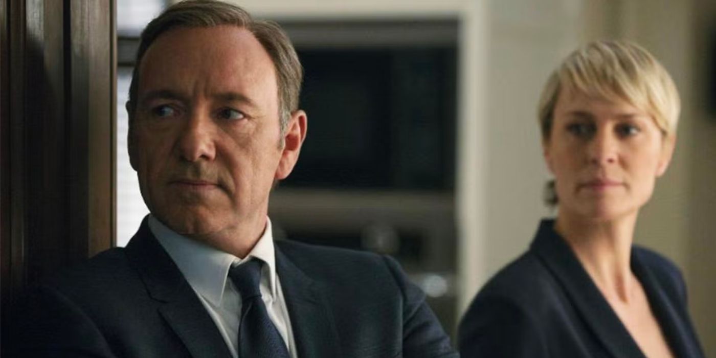 Two characters from House of Cards are standing in a doorway. 