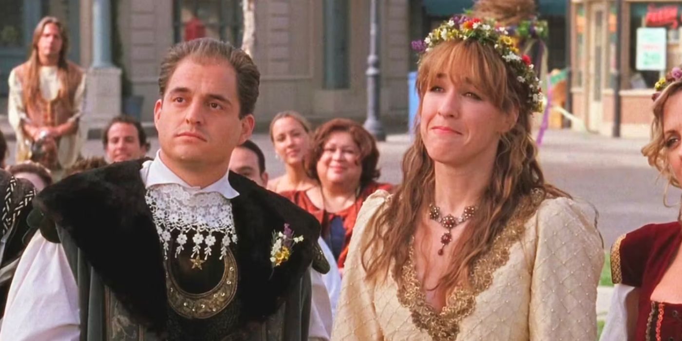 Liz is standing in medieval attire.