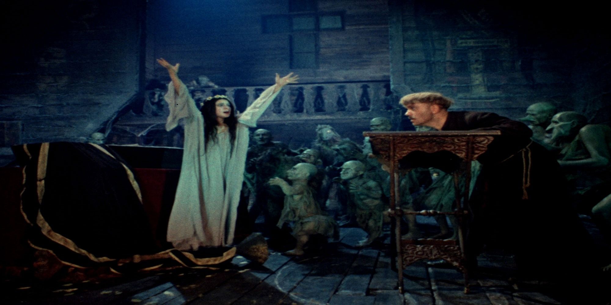 A woman in white raises her arms in Viy