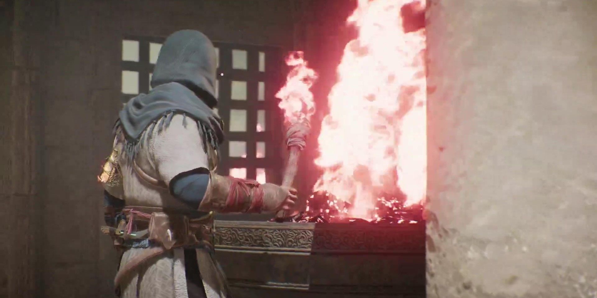 Basim lighting a fire in Assassin&rsquo;s Creed Mirage
