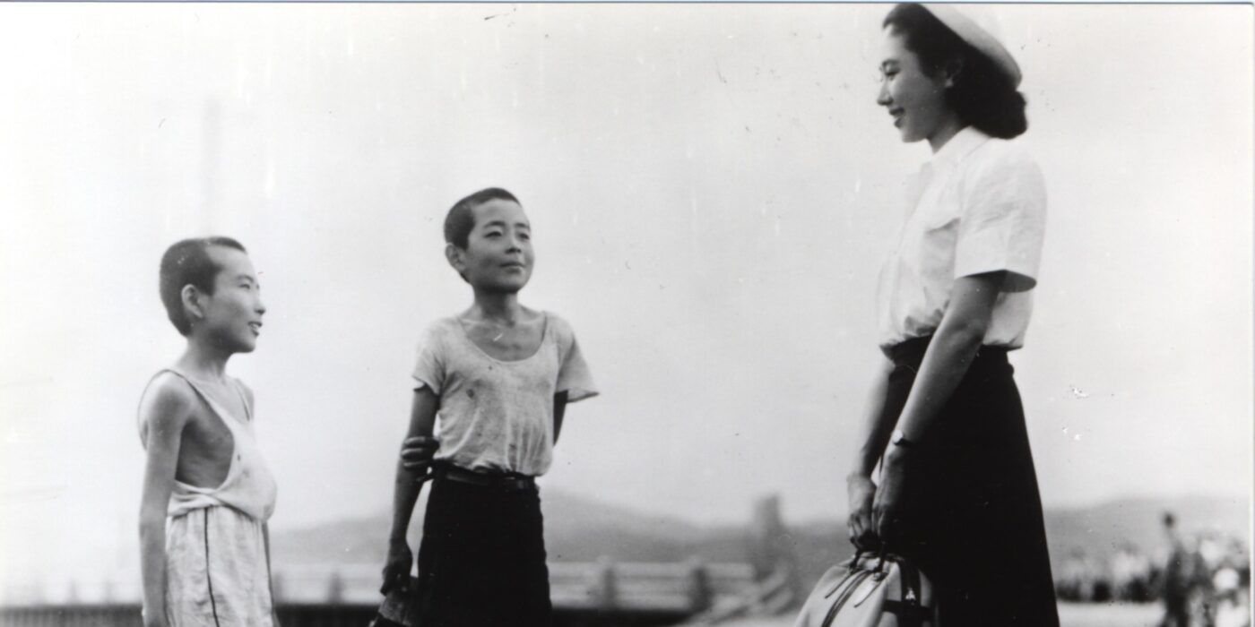 Two children and a woman in a still from Children of Hiroshima 1952