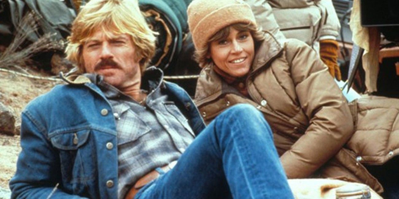Robert Redford and Jane Fonda lounging on the ground in The Electric Horseman