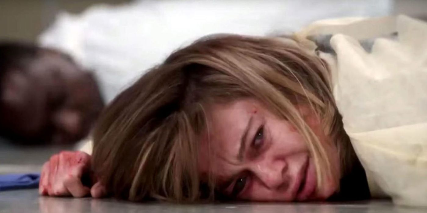Meredith is lying on the ground.