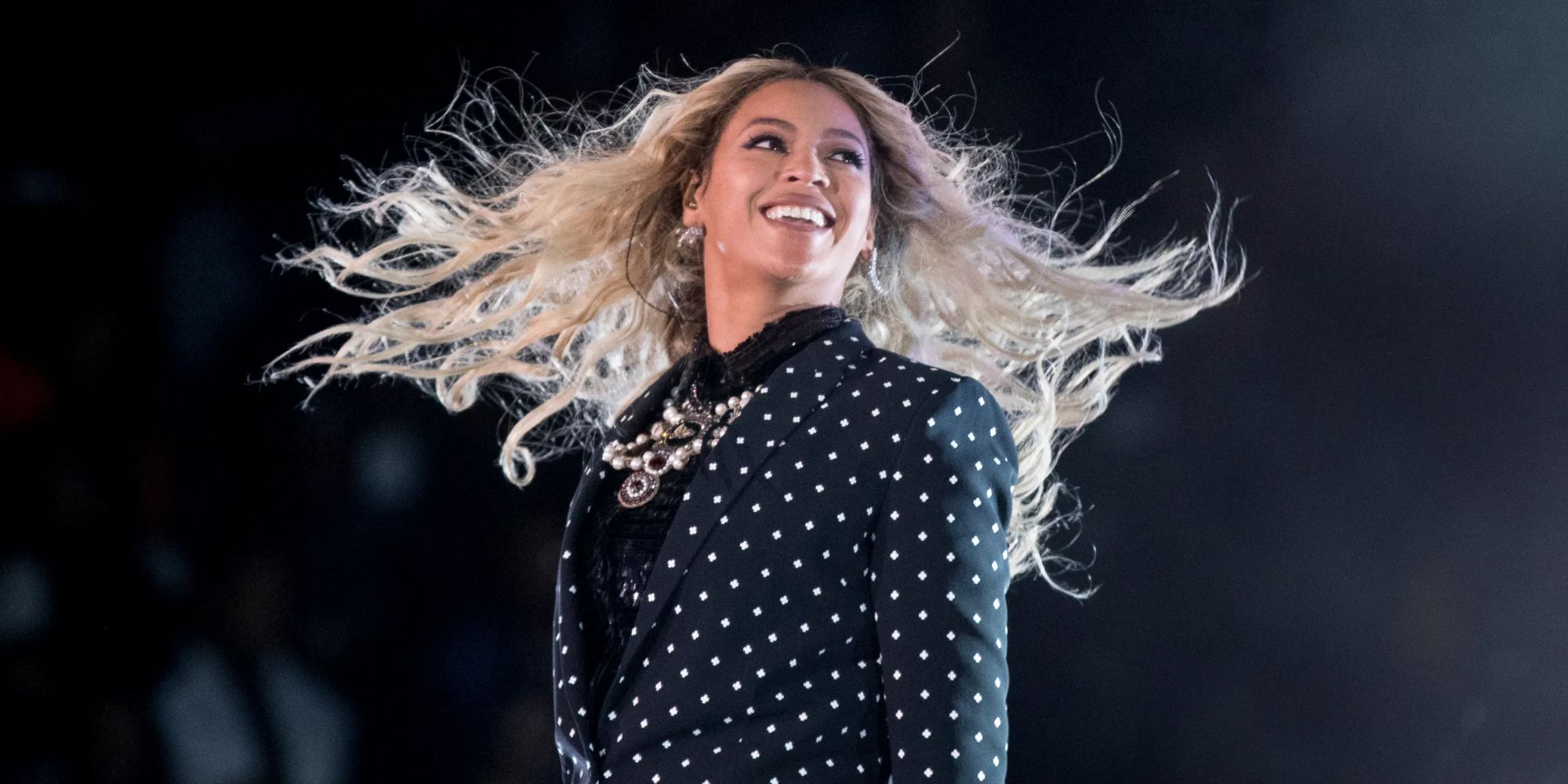 Beyonce is smiling on stage during a concert