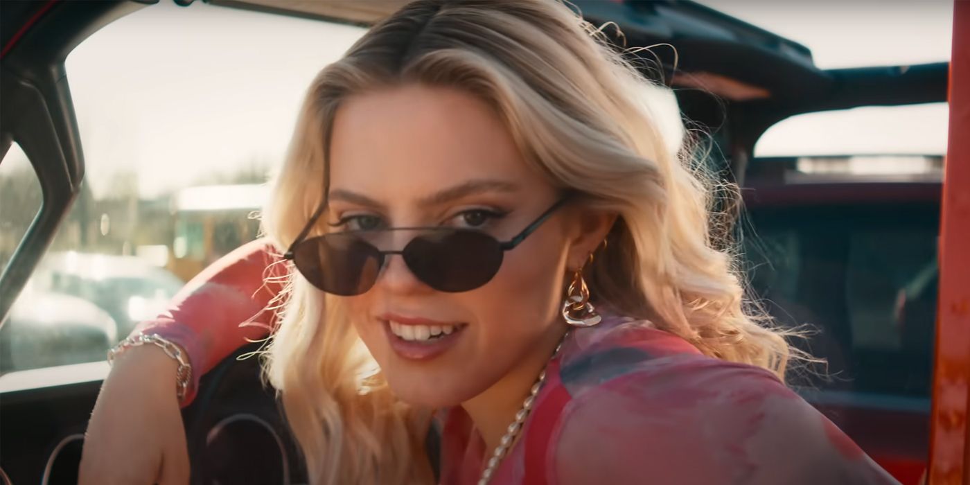 Reneé Rapp as Regina George wearing sun glasses and driving a car in Mean Girls 2024