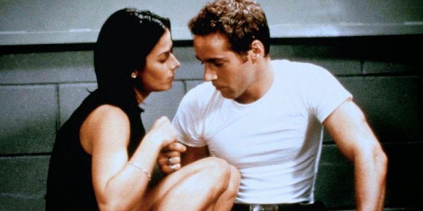 A couple embrace in a prison cell in Reach the Rock 1998