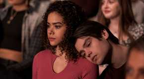 Marcus is resting his head on Ginny's shoulder.