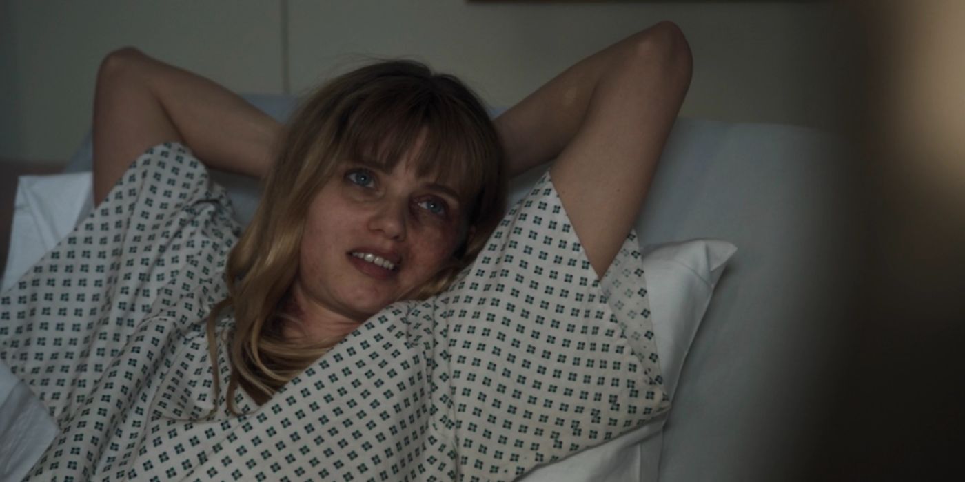 Abbey Lee as Carol Howe lying in a hospital bed with her arms behind her head in Waco the Aftermath.