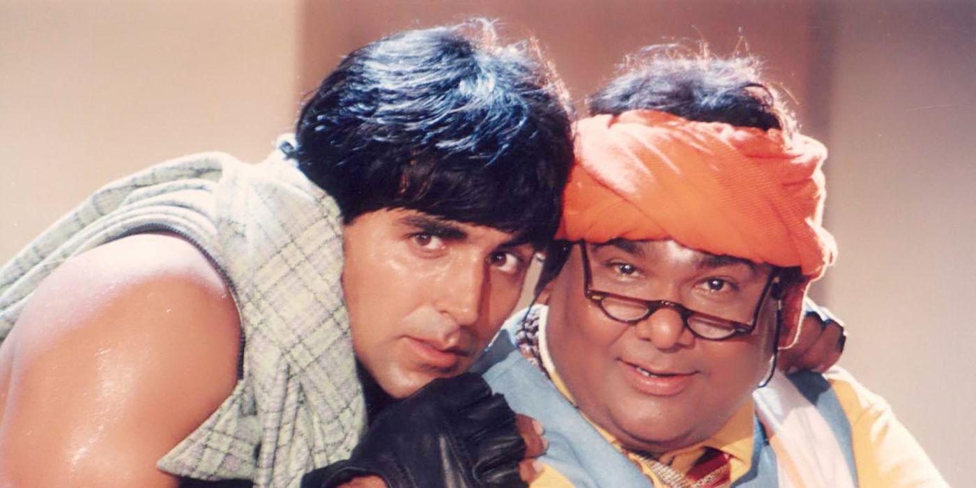 Akshay Kumar as Mr. Khiladi looking scared and leaning up against another man smiling.