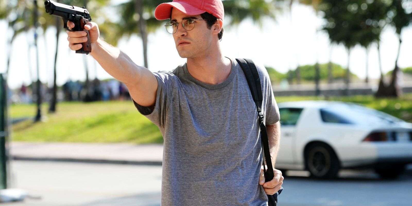 Andrew Cunanan pointing a gun in The Assassination of Gianni Versace: American Crime Story