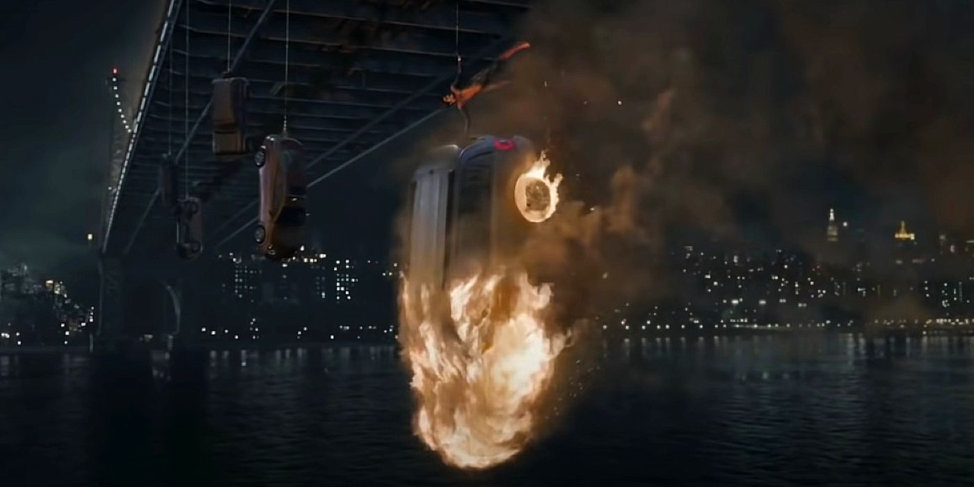 Andrew Garfield as Spider-Man lifting a flaming car in The Amazing Spider-Man