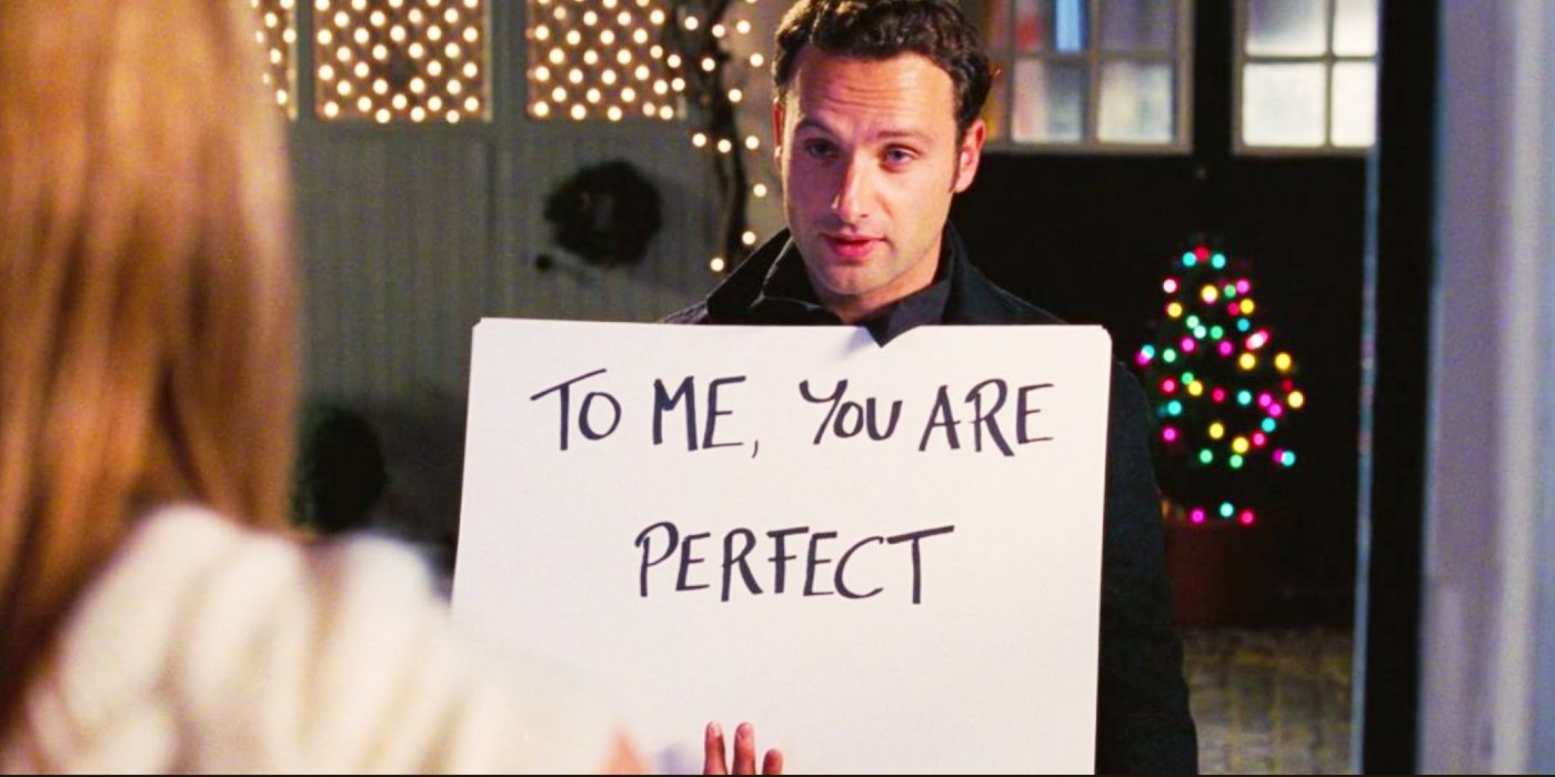 Andrew Lincoln holding a sign that says, 