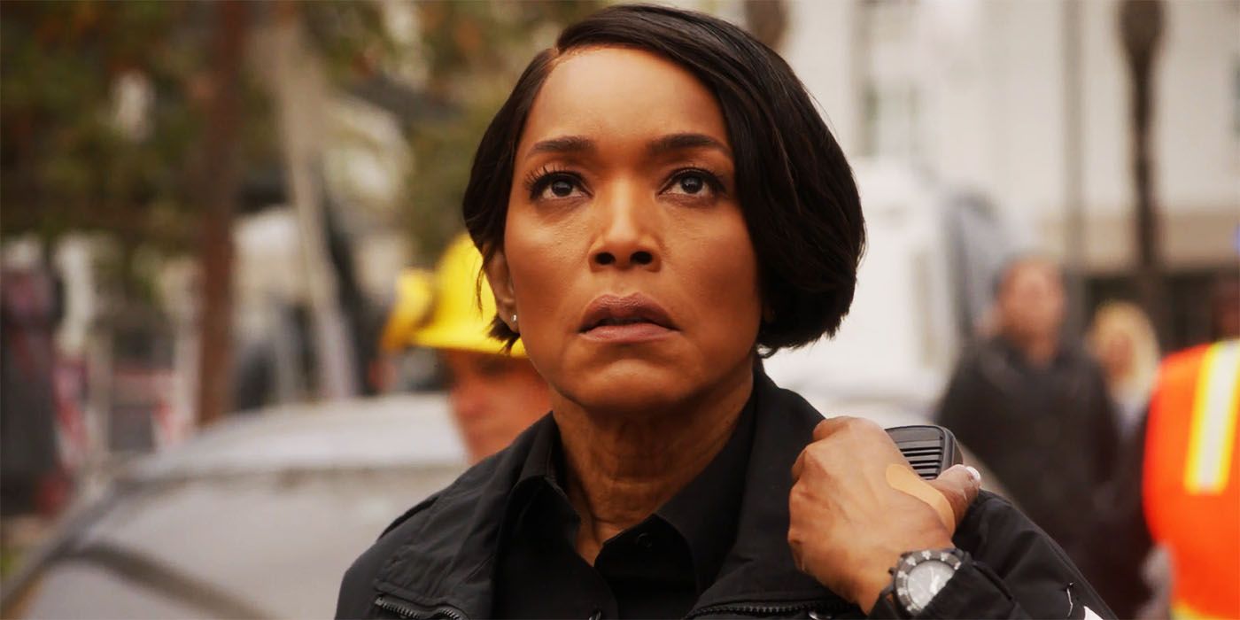 Angela Bassett as Athena in 9-1-1 season 6, episode 18 looking up with concerned expression while touching radio on shoulder