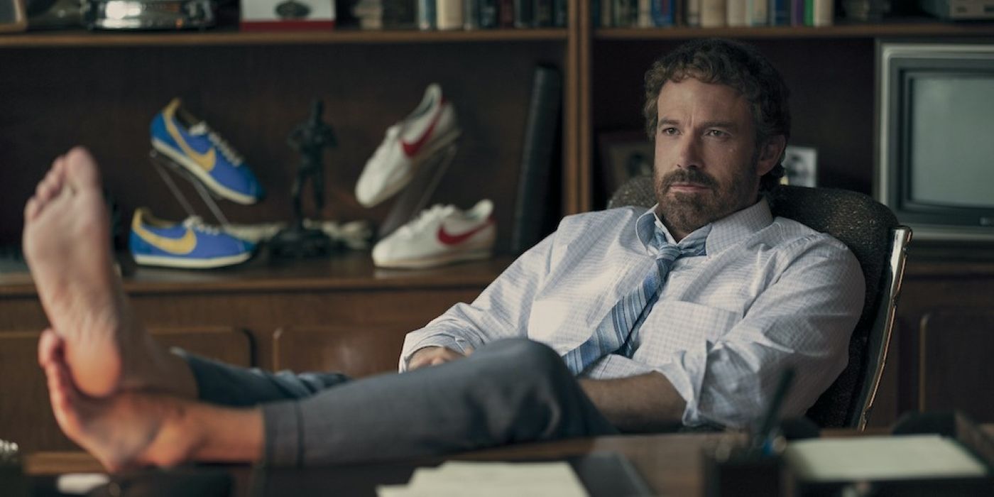 Ben Affleck with his bare feet propped up on a desk in Air