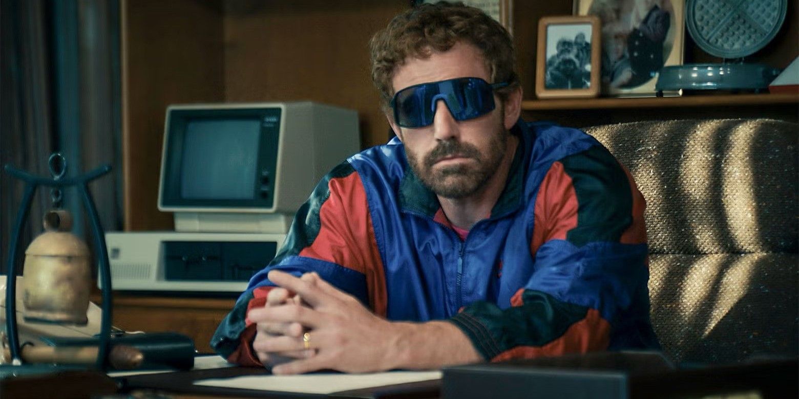 Ben Affleck wearing sunglasses, leaning over a desk in Air