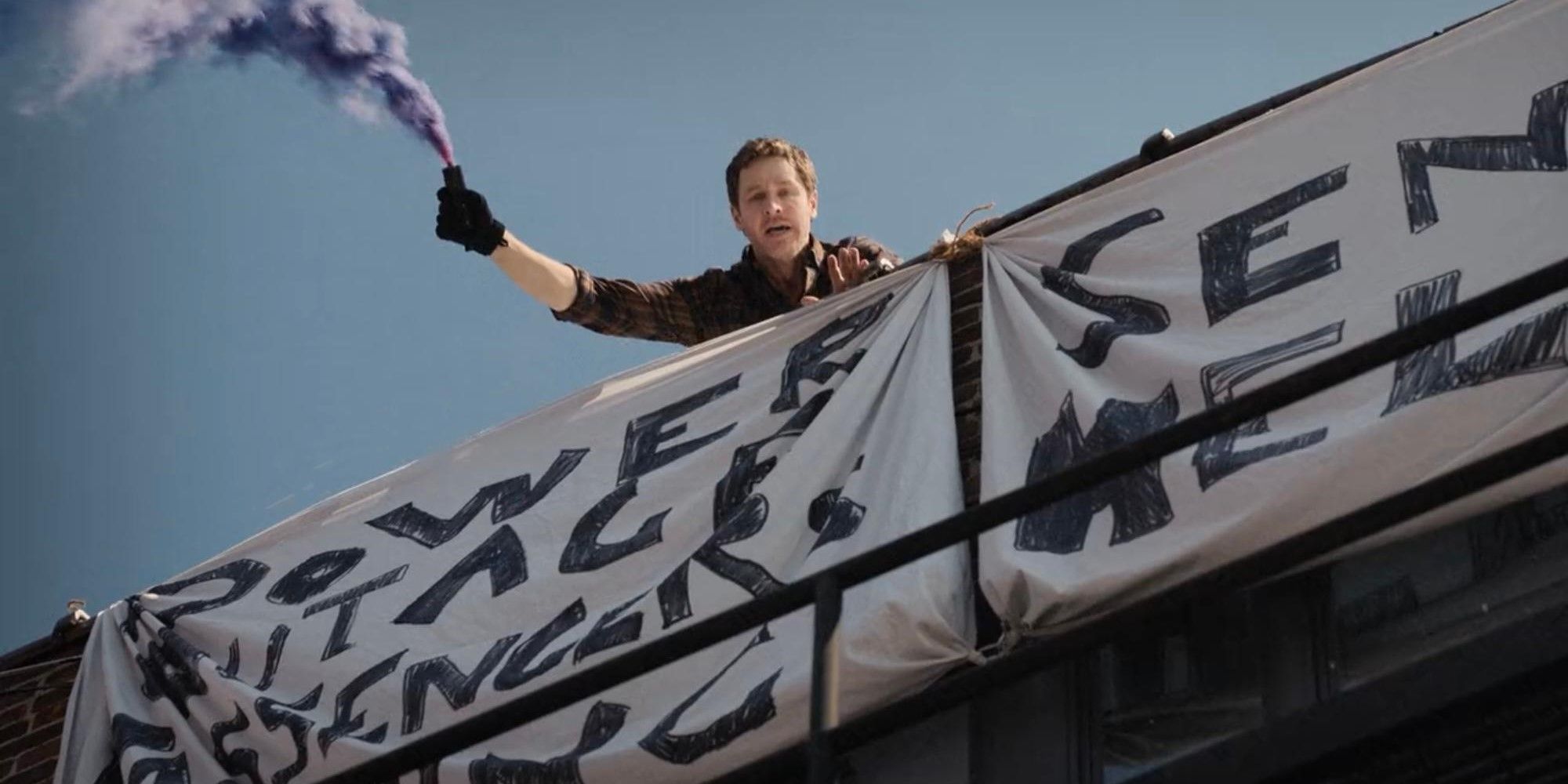 Ben holding up a smoke signal on a roof in Manifest