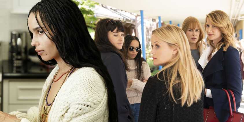 A composite image of Zoe Kravitz looking on in front of the rest of the cast of Big Little Lies