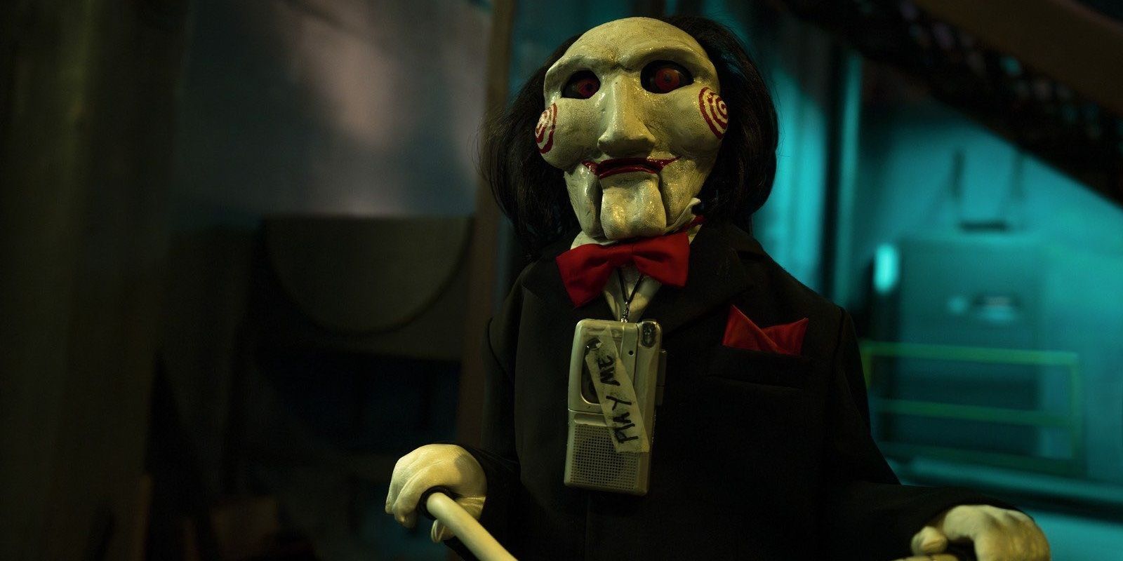 Billy the puppet with a tape recorder in Saw X