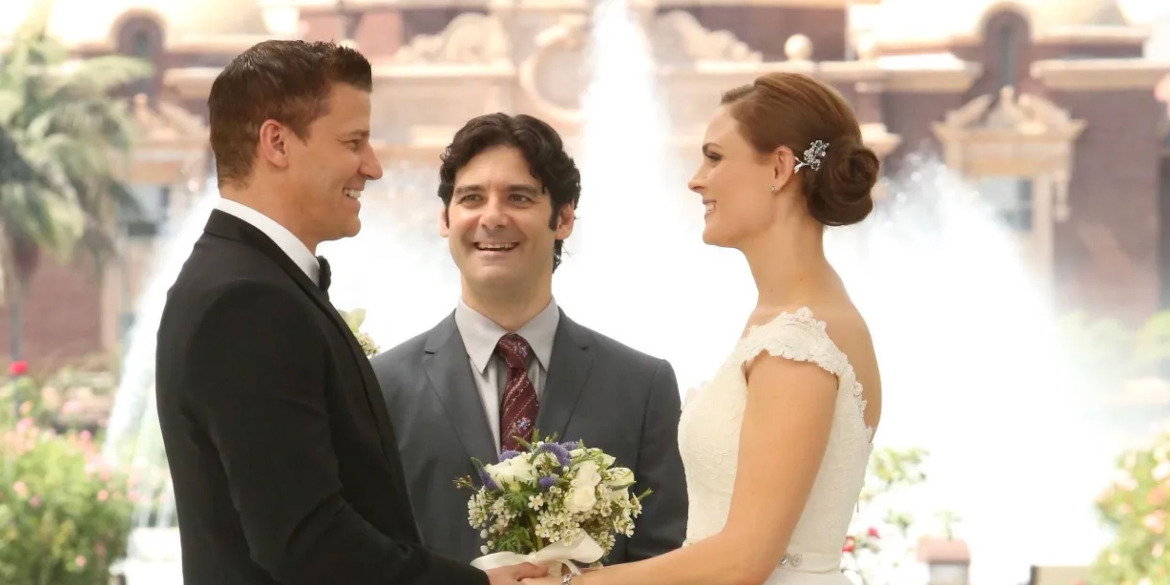 Booth and Brennan smiling at each other on their wedding day in Bones