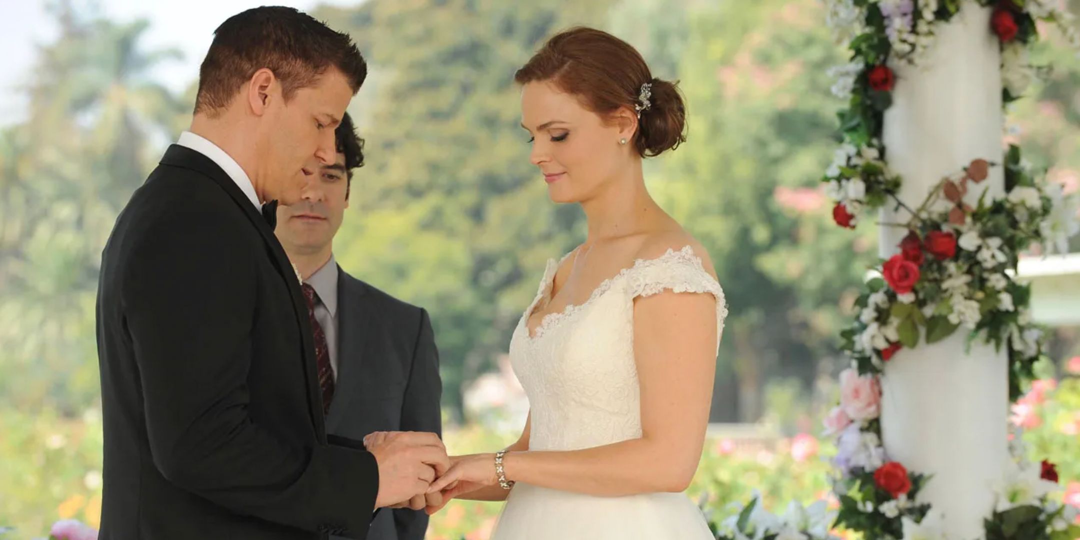 Booth putting a ring on Brennan on their wedding day in Bones