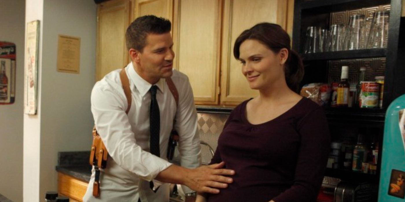 Booth with his hand on.the stomach of a pregnant Brennan in Bones