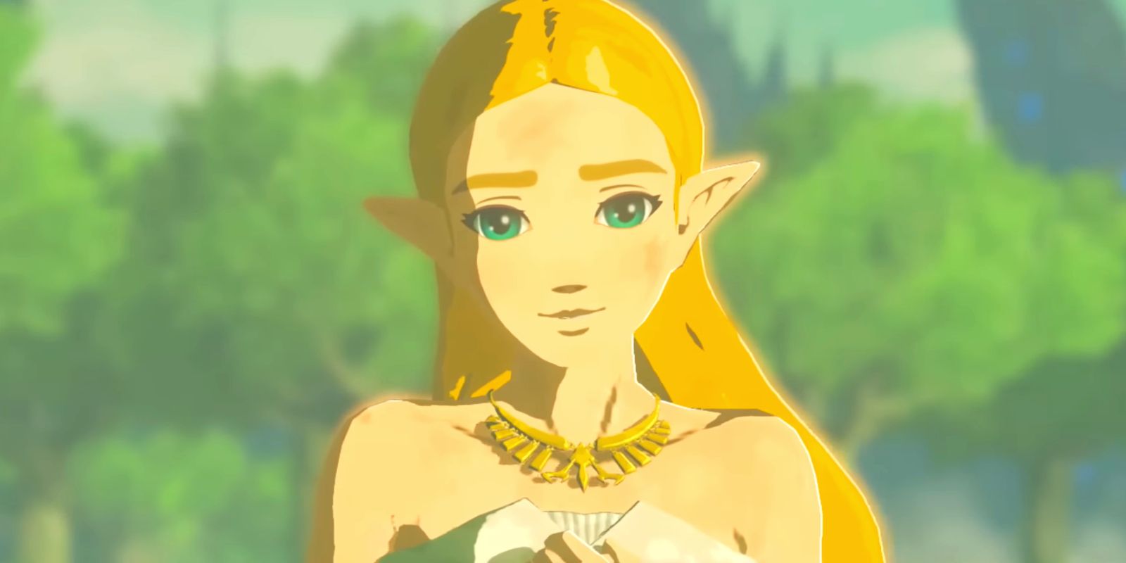 Zelda looking directly at the camera, head slightly tilted and smiling. Her hands are clasped in front of her.