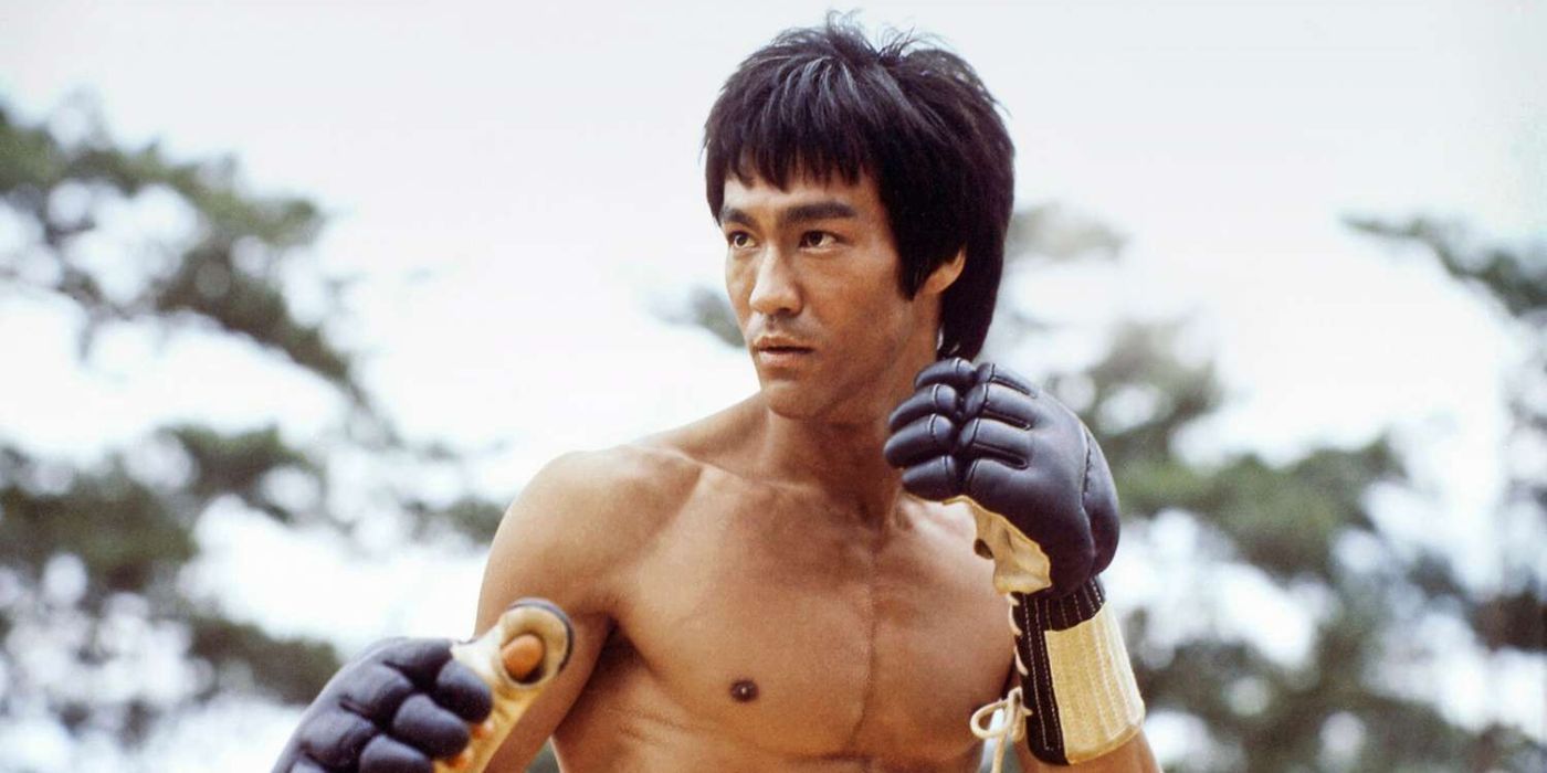 Bruce Lee shirtless in Game of Death's intro adopting a mixed martial arts stance against an opponent