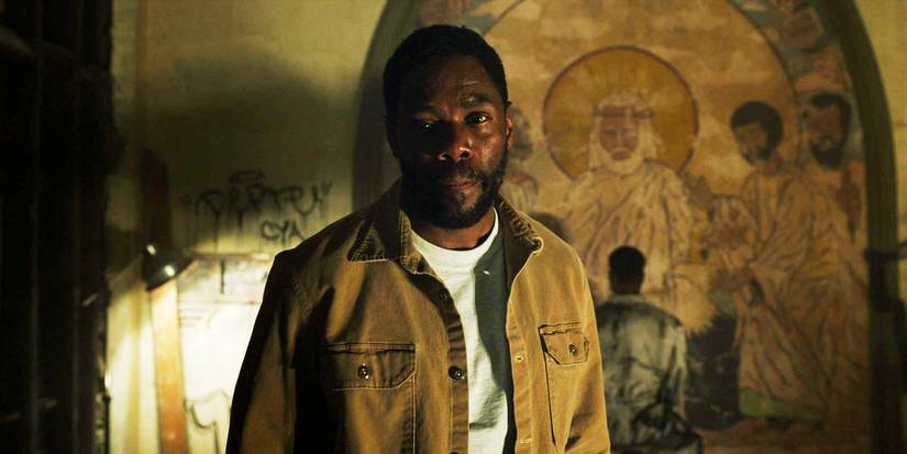 Candyman 2021 William looking serious at an abandoned church