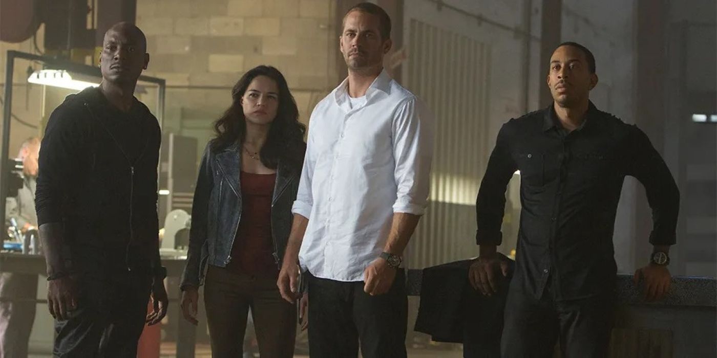 Roman, Letty, Brian, and Tej looking at something off-camera in Furious 7