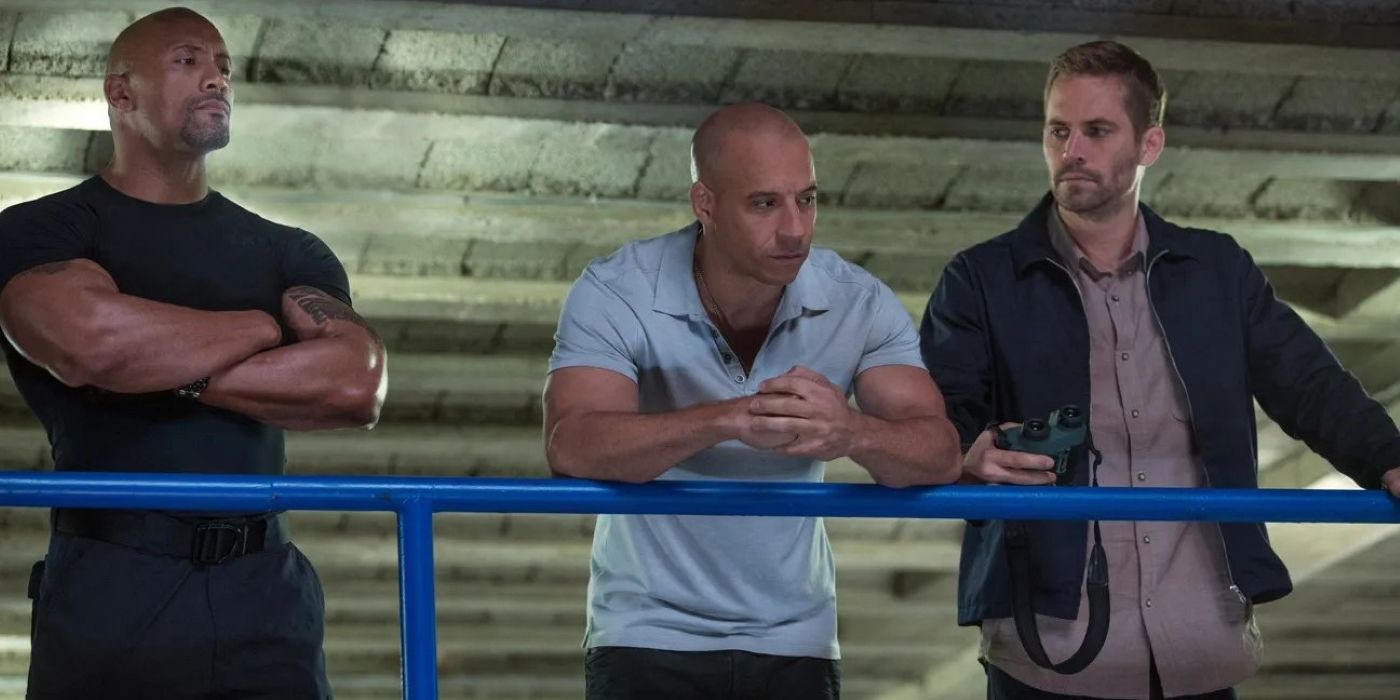 Hobbs (Dwayne Johnson), Dom (Vin Diesel), and Brian (Paul Walker) looking serious in Furious 7