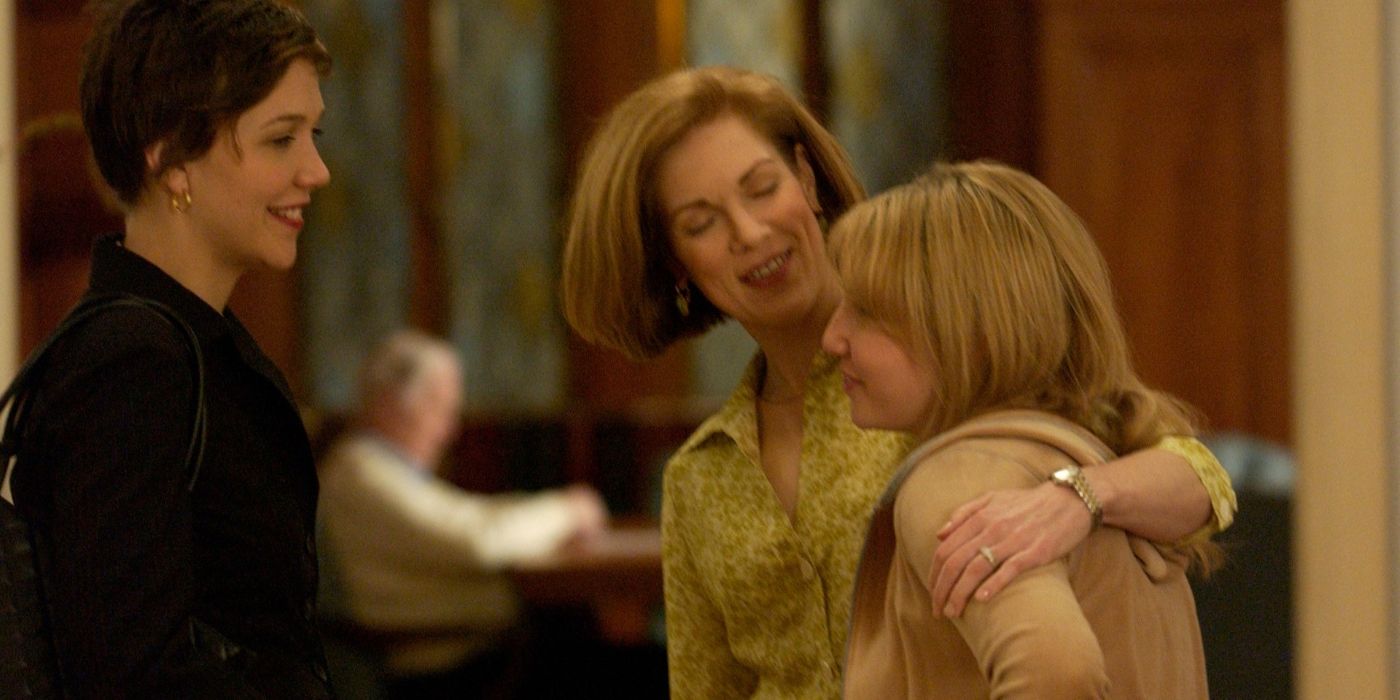 Maggie Gyllenhaal smiles as one woman puts her arm around a younger woman in Great New Wonderful