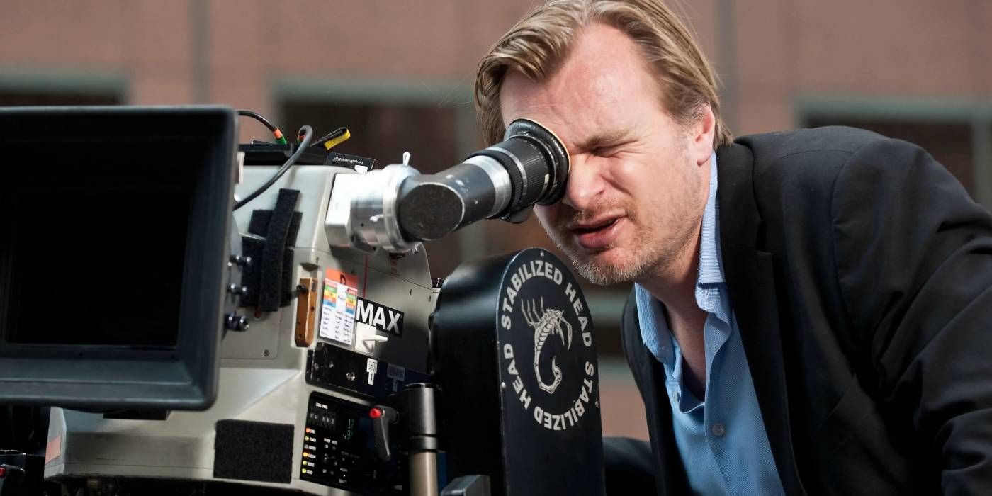 Christopher Nolan looking into a camera directing Oppenheimer