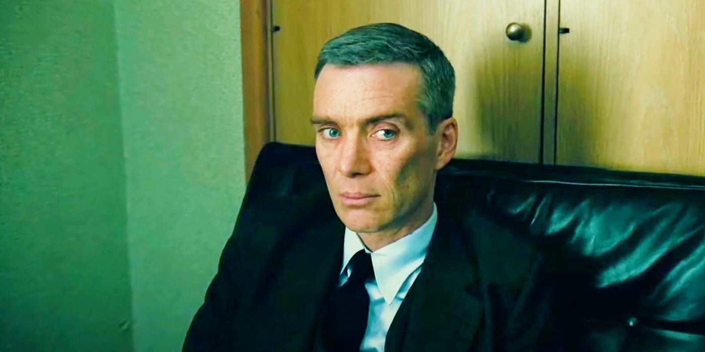 Cillian Murphy sitting in a leather chair during a hearing in Oppenheimer.