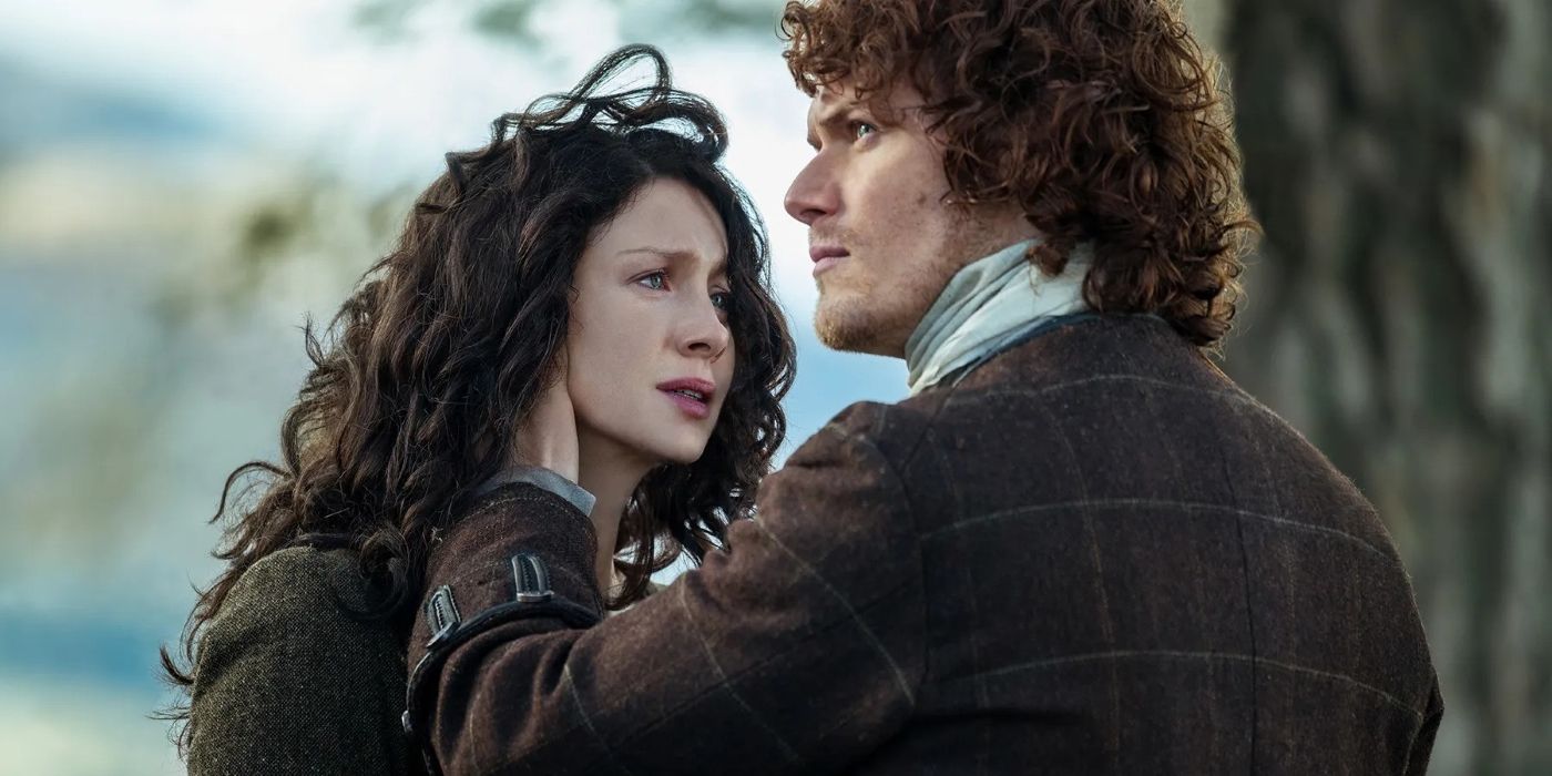 Jamie holding Claire's head as she looks distressed in Outlander