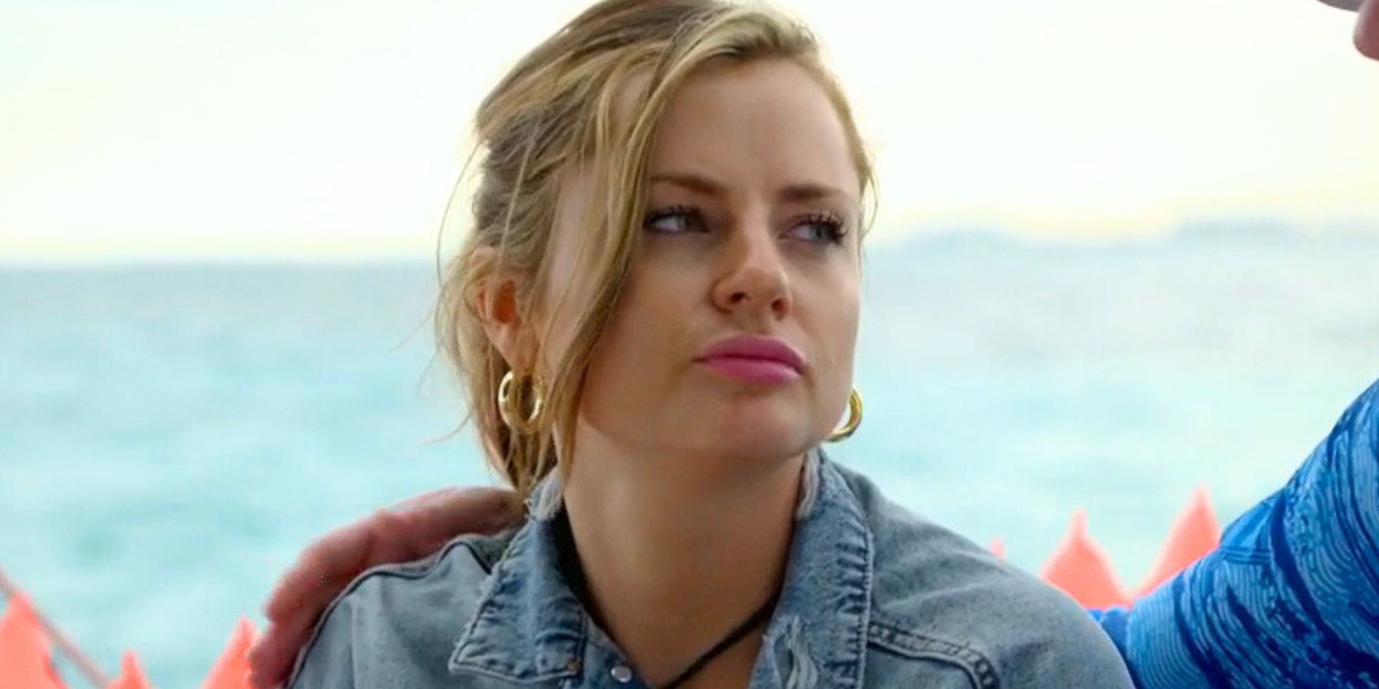 Clare Kerr from Married At First Sight Season 17 in jean jacket grimacing looking at cameron