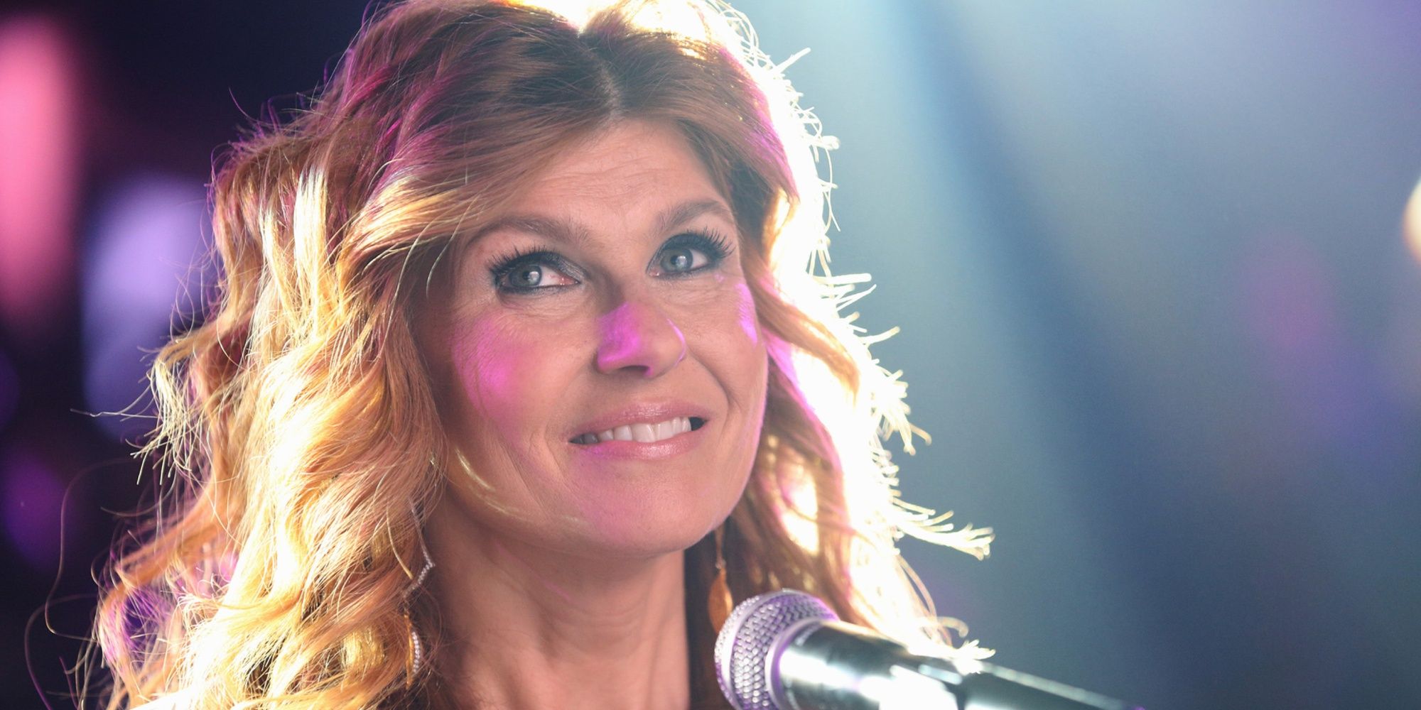 Rayna James on stage smiling in Nashville