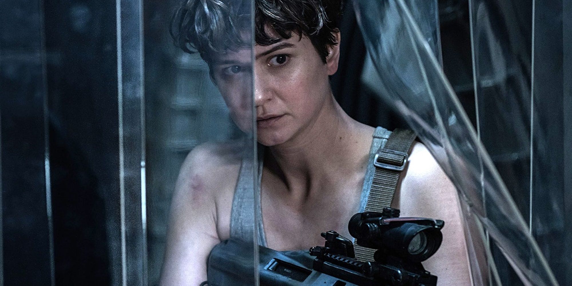 Daniels pushing through plastic sheeting with a gun in Alien: Covenant